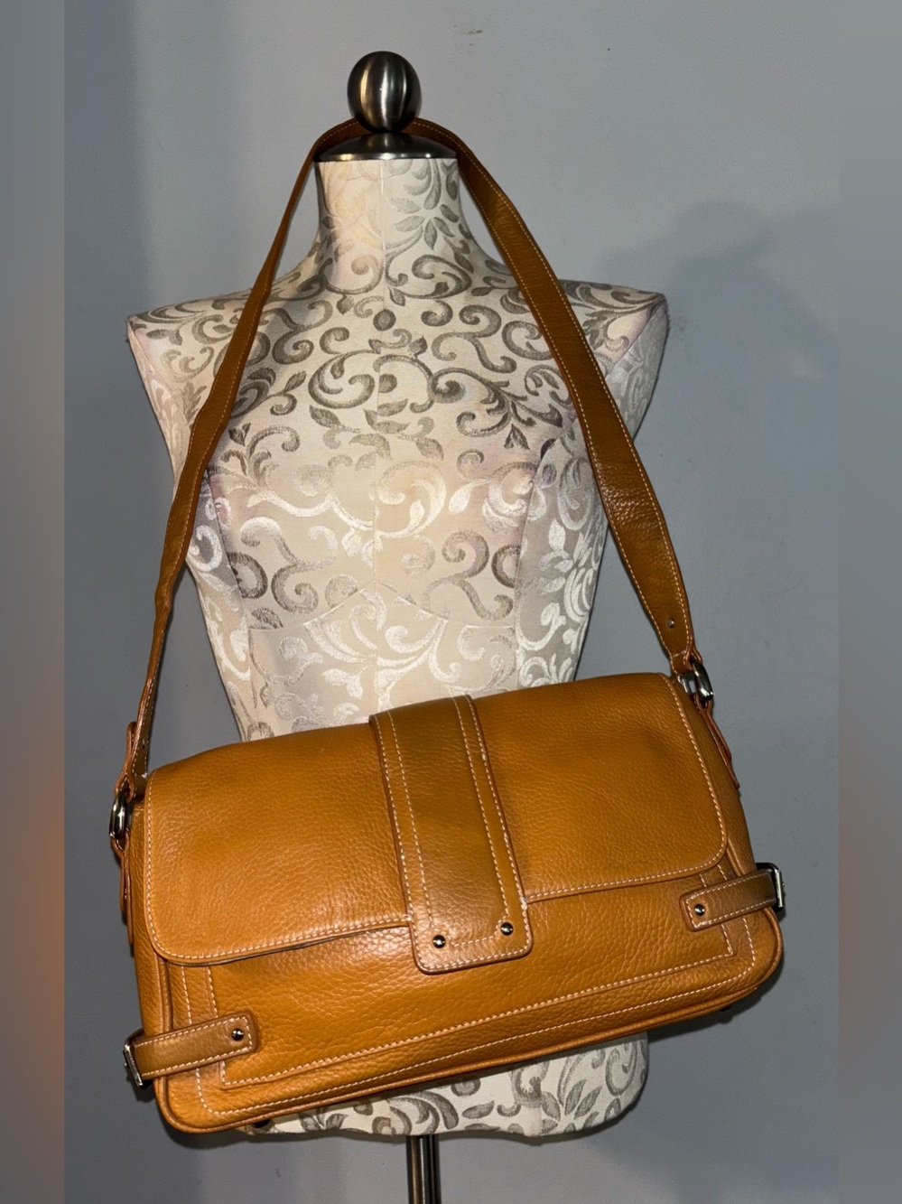 Tignanello pebbled leather shoulder bag rendered in a rich tan/cognac shade. #A